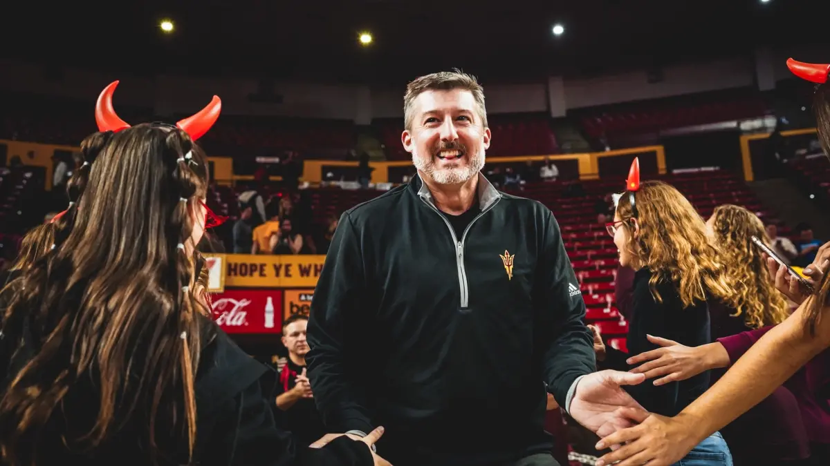 Jay Santos high fives fans in Desert Financial Arena