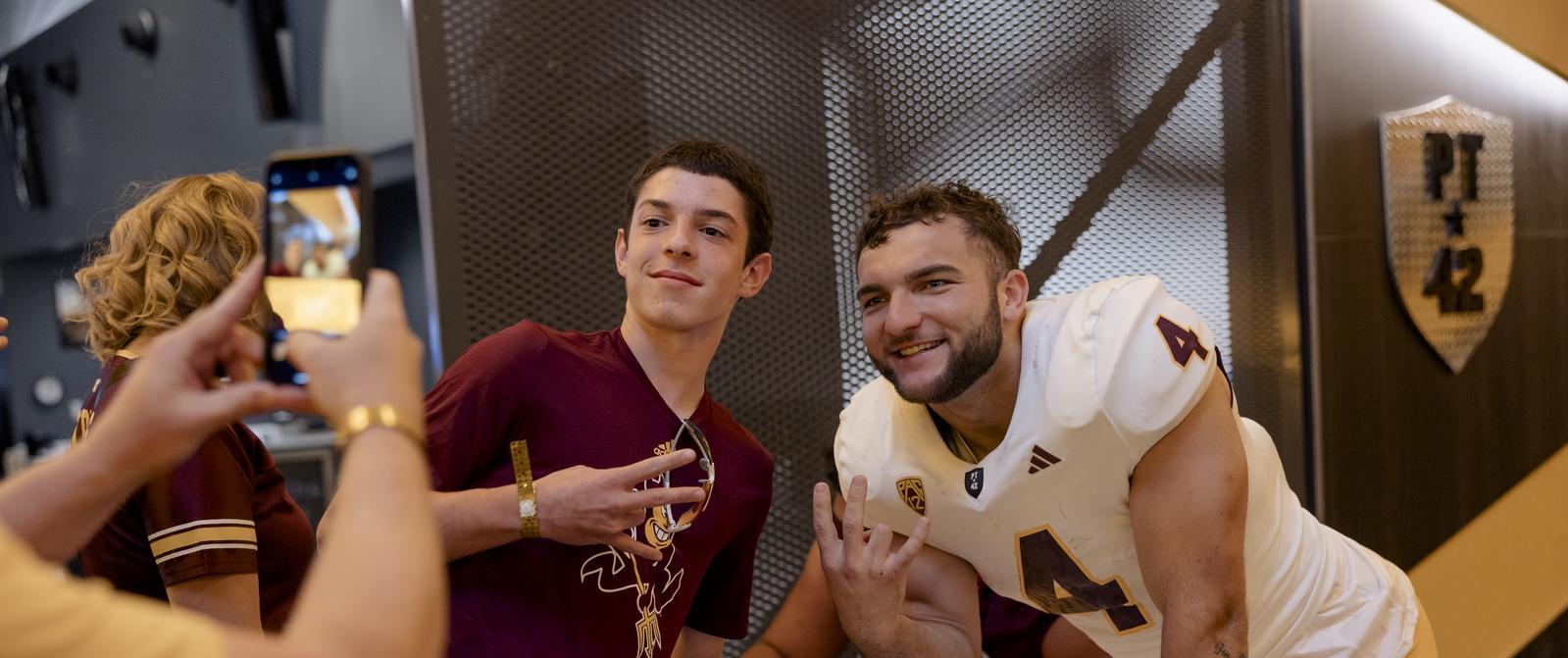 Sun Devil Football player smiling for photo with fan