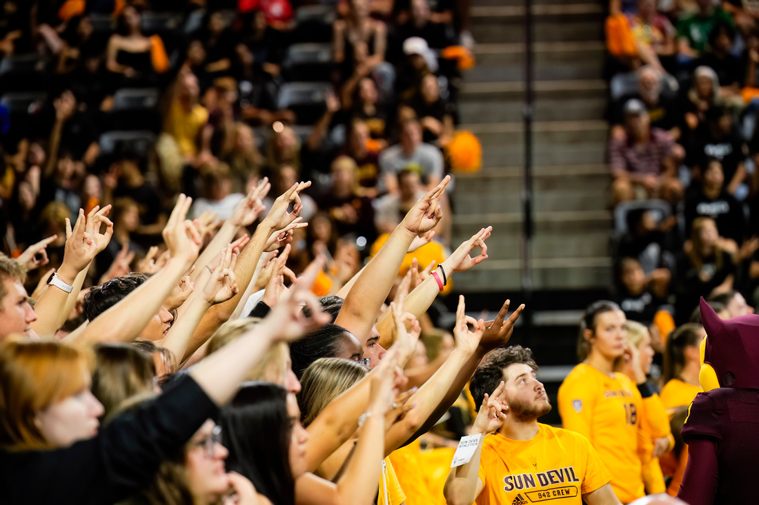 Fans in stadium holding up the Sun Devil hand pitchfork