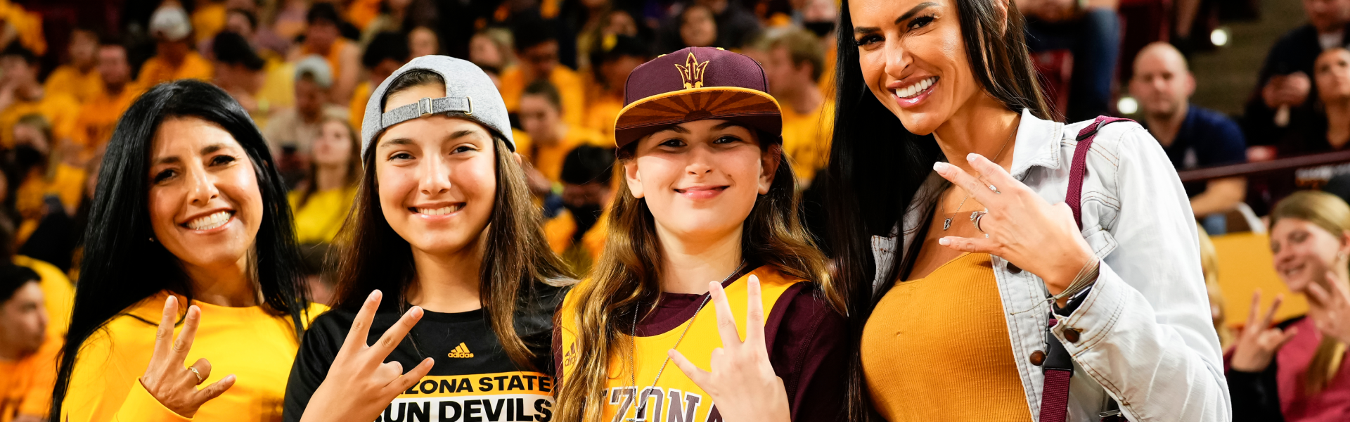 Girls at basketball game wearing ASU merchandise