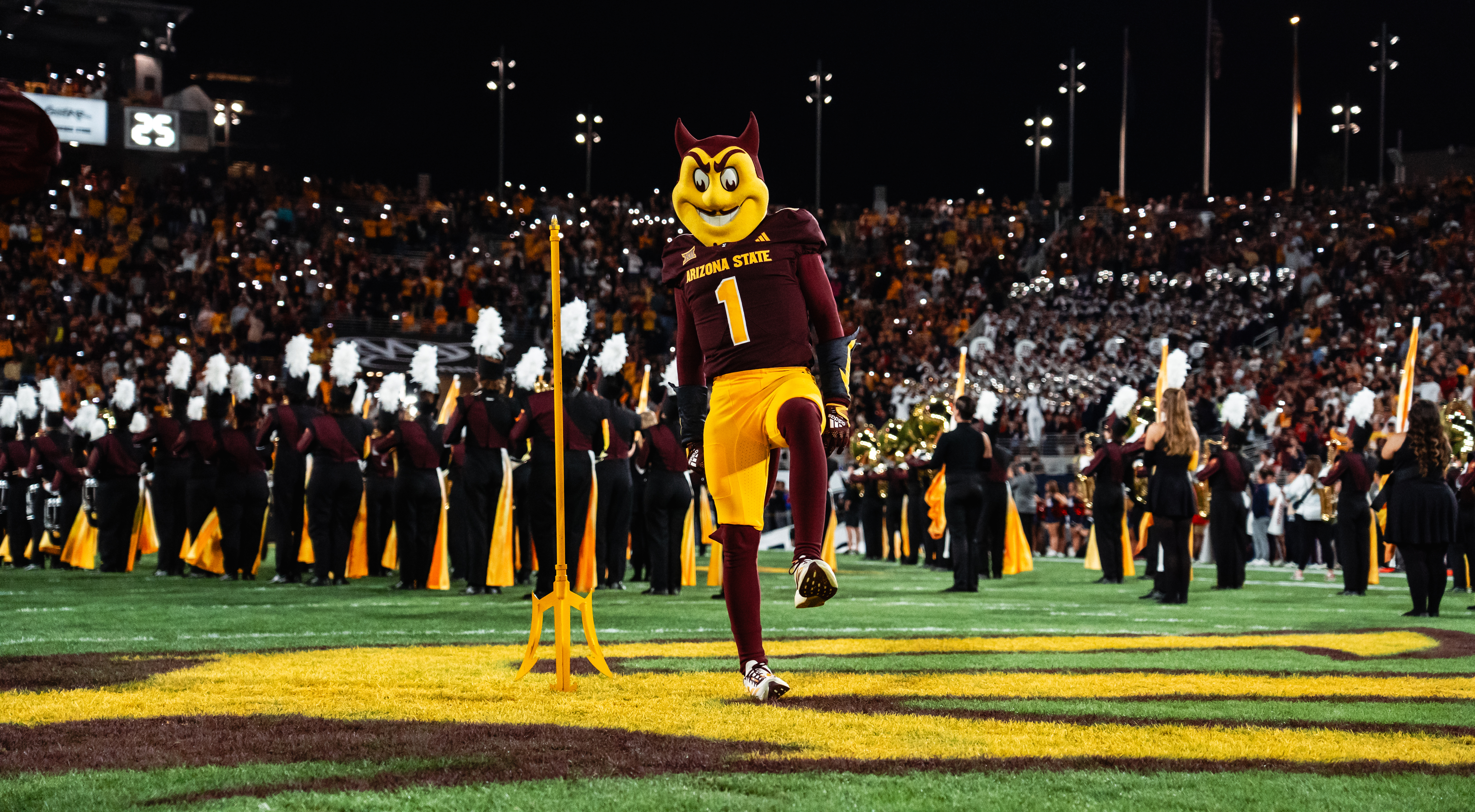 Sparky with the pitchfork on the field before the Territorial Cup game