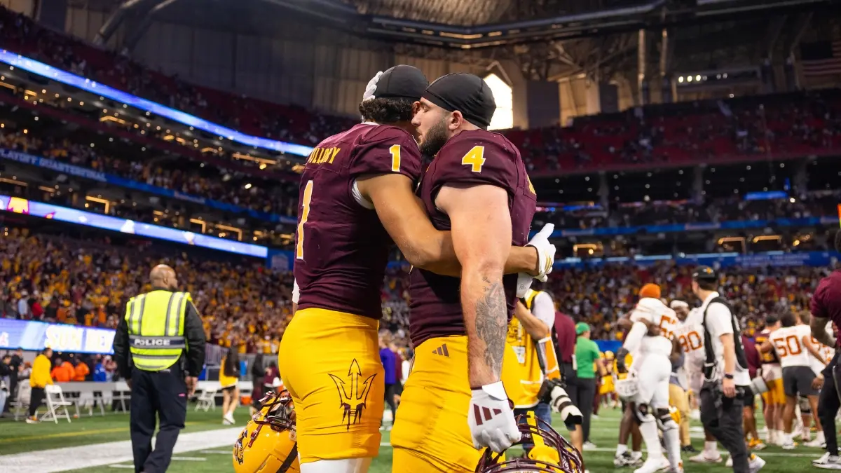 Two ASU football players hug after their Peach Bowl loss