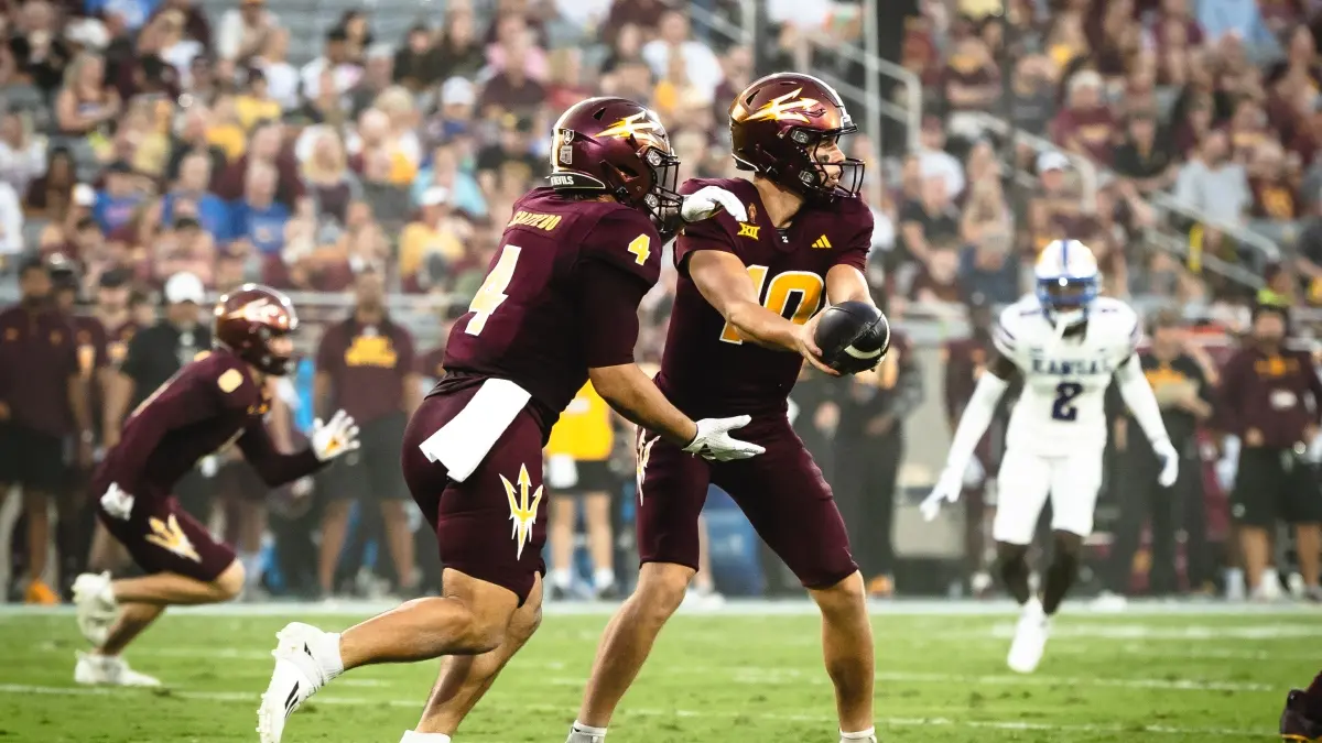 Sam Leavitt hands off to Cam Skattebo