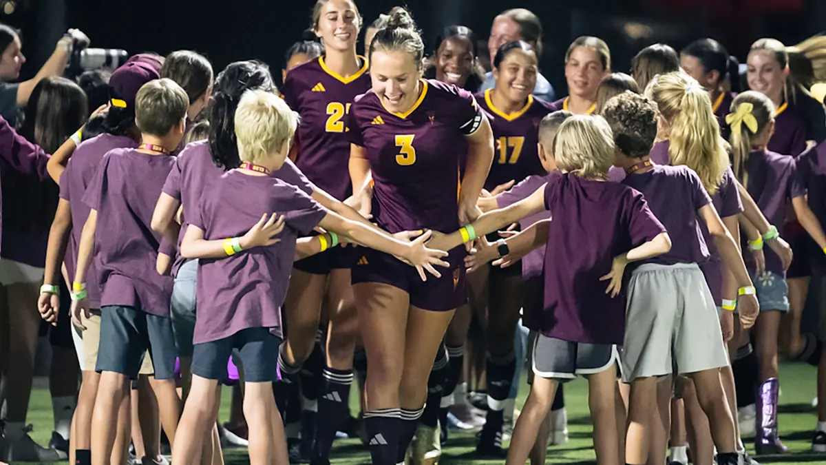 Lucy Johnson celebrates being introduced before a game with children Lucy Johnson celebrates being introduced before a game with children