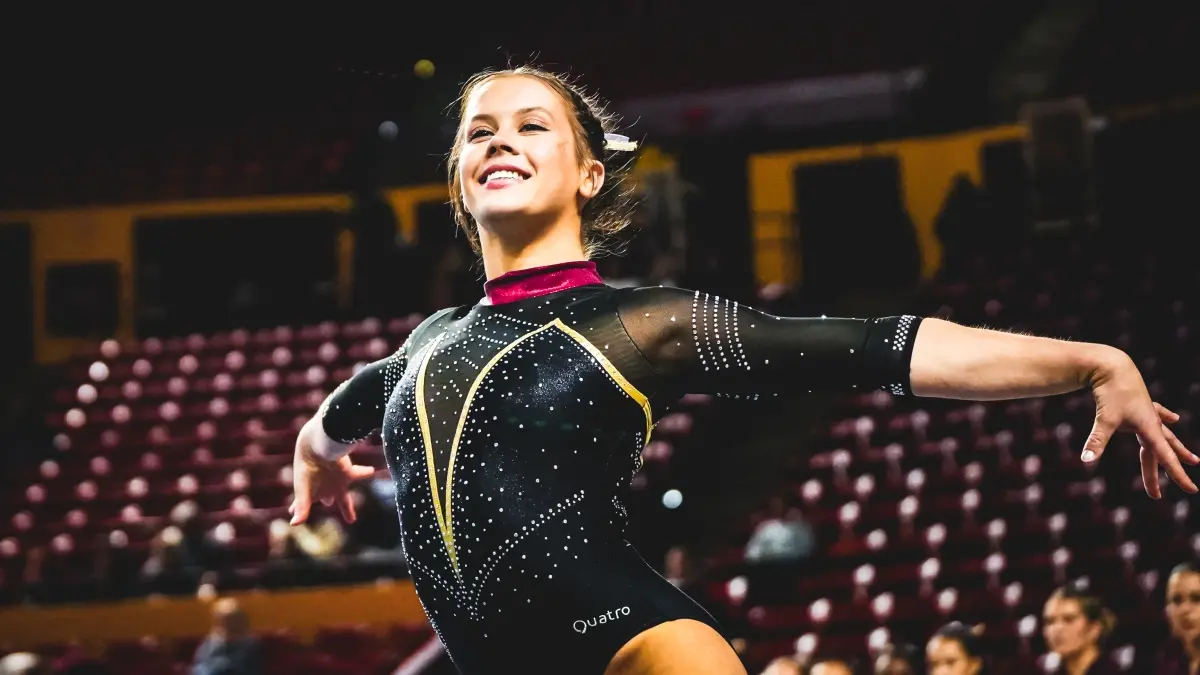Kayla Lee poses while performing her floor routine in Desert Financial Arena. Kayla Lee poses while performing her floor routine in Desert Financial Arena.