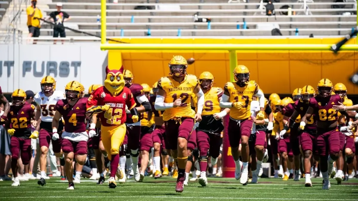 Image from ASU News football players running onto field