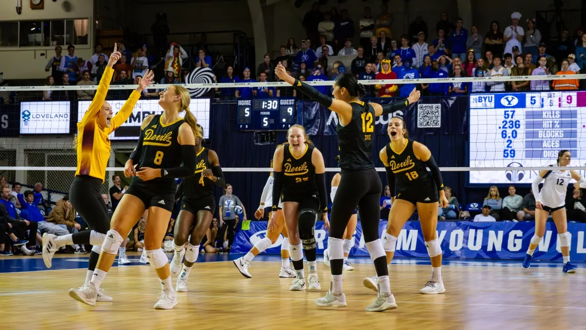 Volleyball players celebrating after winning a rally. Volleyball players celebrating after winning a rally.
