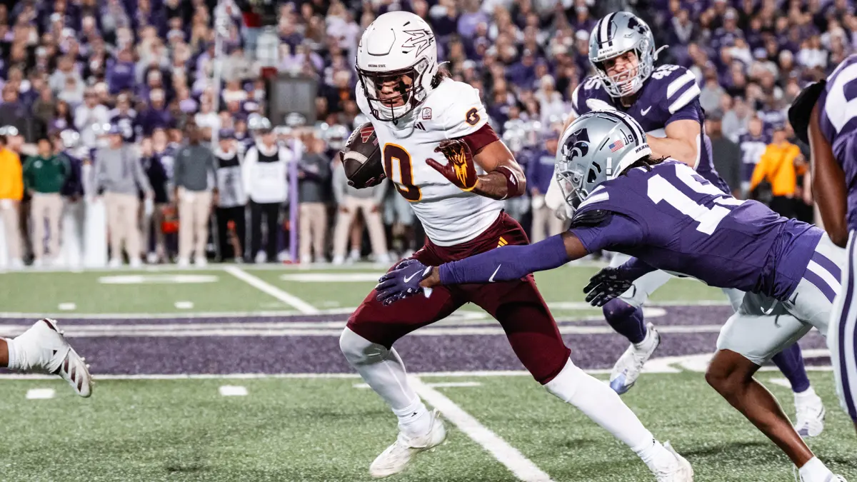 Jordyn Tyson fights for more yards after making a catch against Kansas State