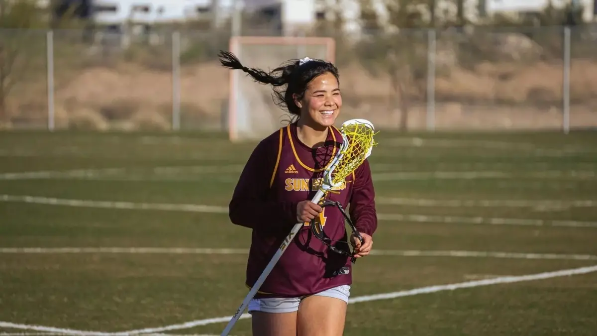 Helen Park smiles while running across the field. Helen Park smiles while running across the field.
