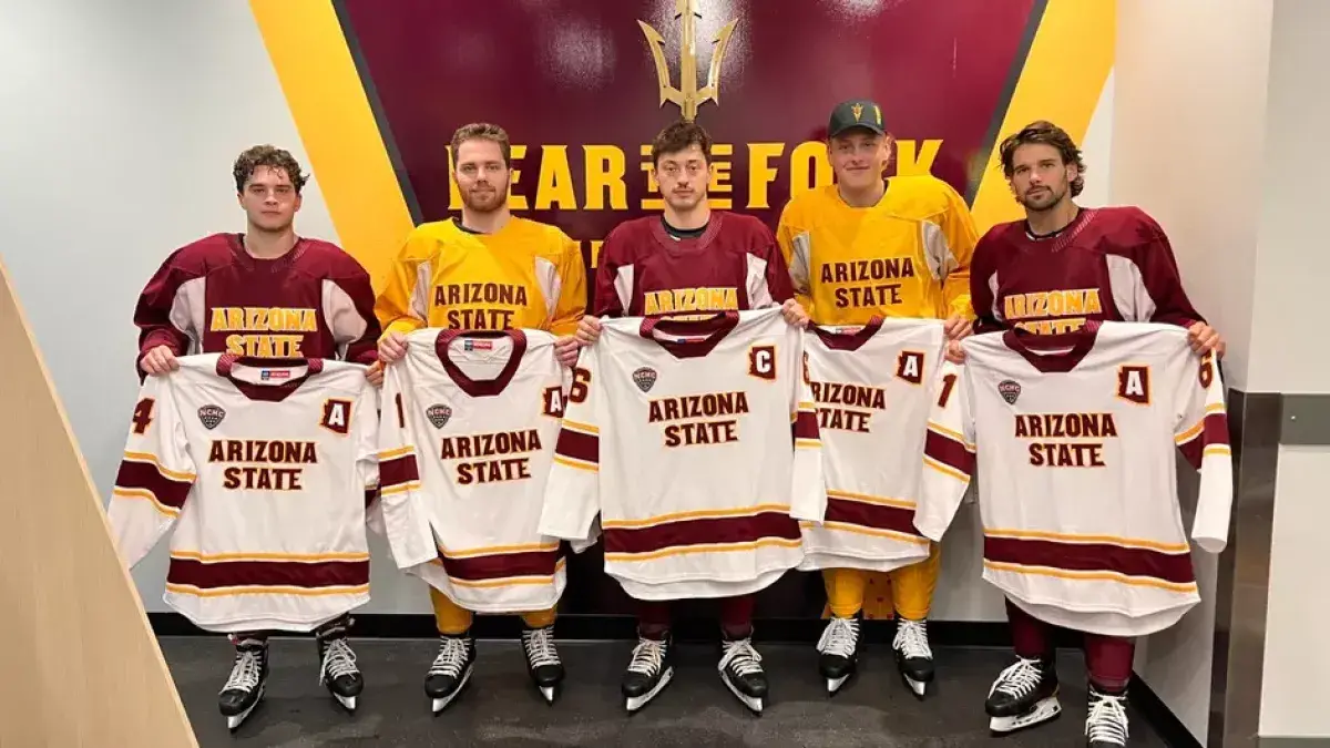 Ice hockey captains standing together holding their jerseys