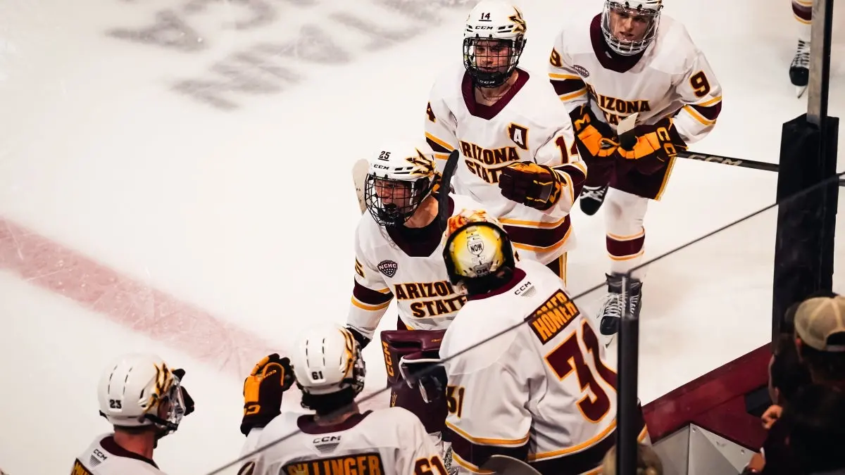 Kyle Smolen high fives teammates after scoring vs. WMU