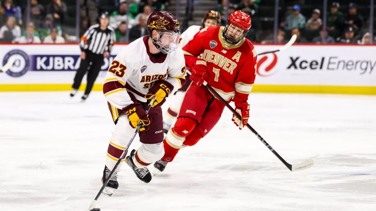 Bennett Schimek skates with puck vs. Denver Bennett Schimek skates with puck vs. Denver
