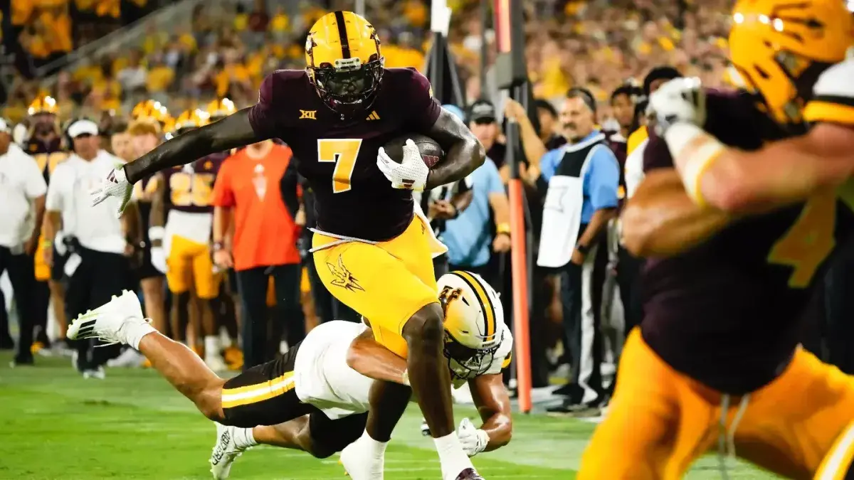 Sun Devil Football athlete running down the field with the ball Sun Devil Football athlete running down the field with the ball