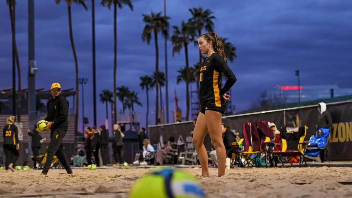 Kendall Whitmarsh stands in the sand, preparing for the serve. Kendall Whitmarsh stands in the sand, preparing for the serve.