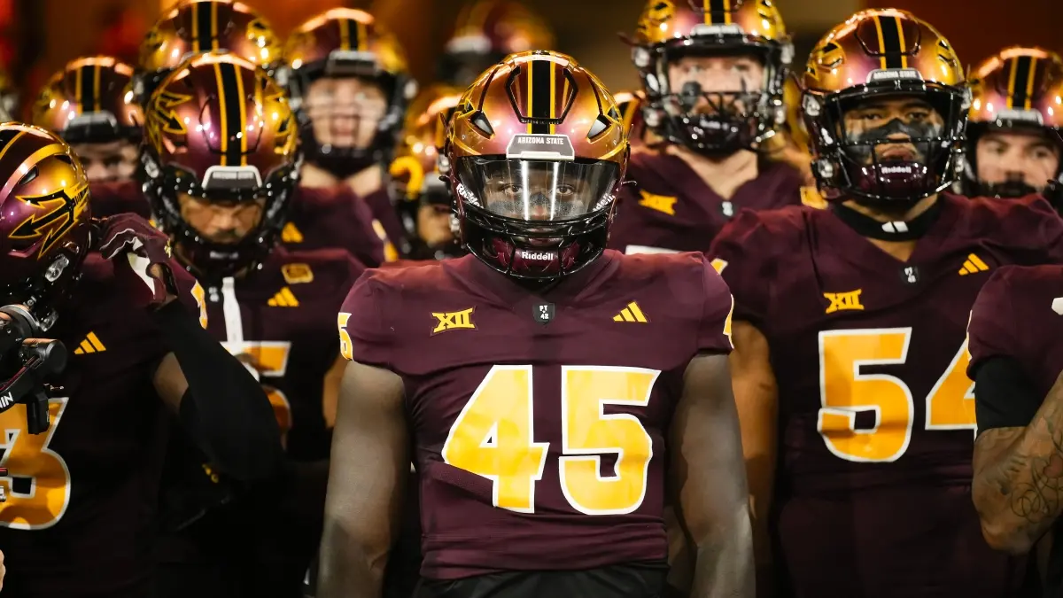 K&#039;Vion Thunderbird leads the Sun Devils onto the field.