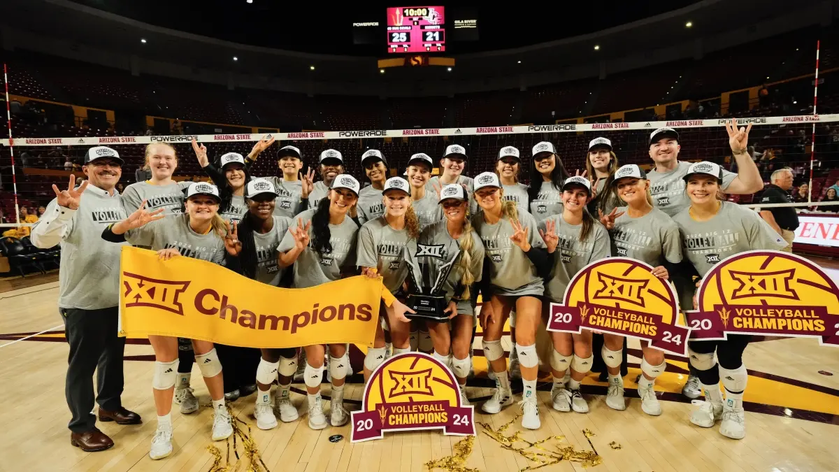 Volleyball team celebrates winning Big 12 Championship with posters, hats and shirts. Volleyball team celebrates winning Big 12 Championship with posters, hats and shirts.