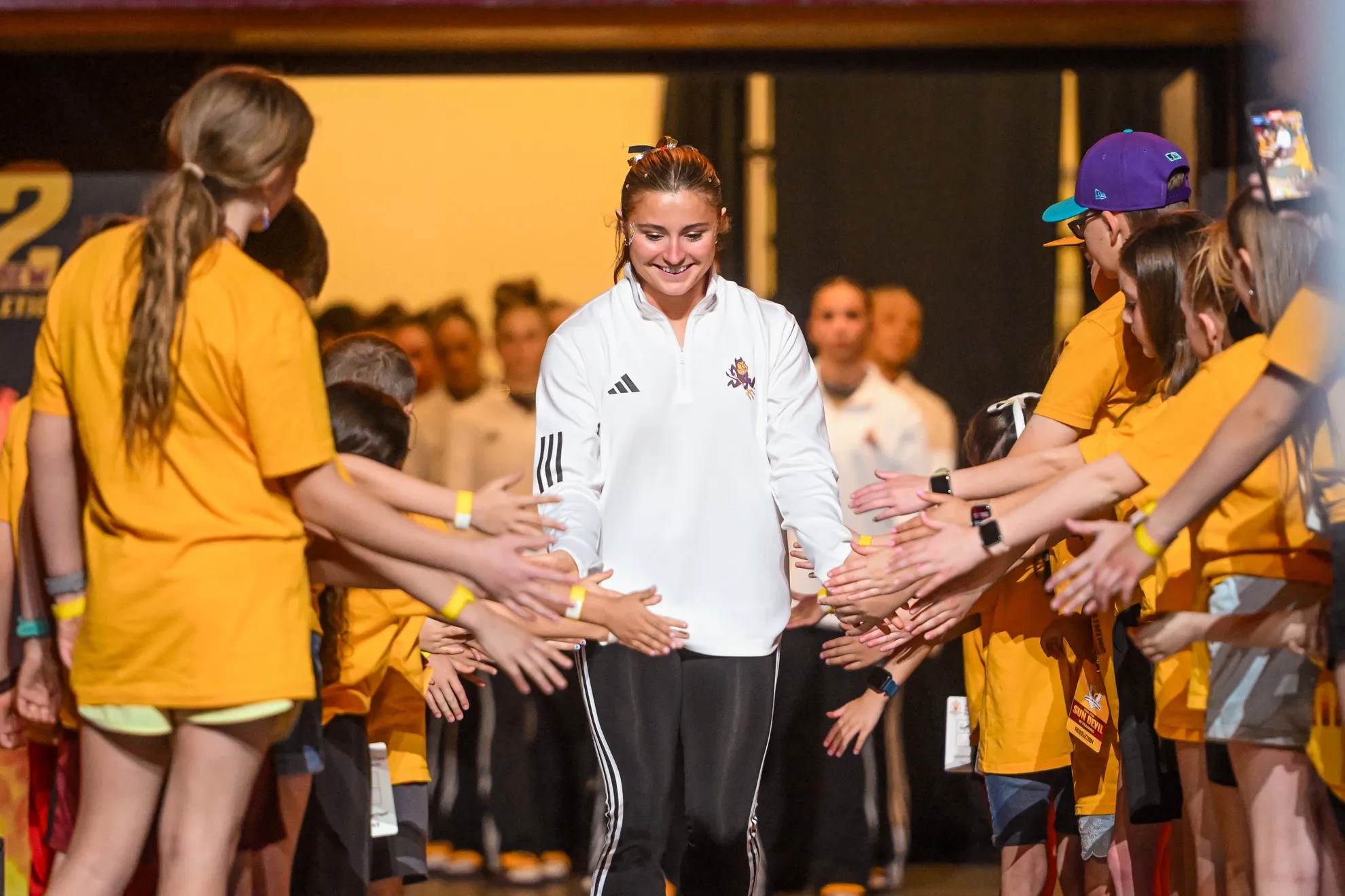 Jessica Rosenberg high fiving fans during introductions.