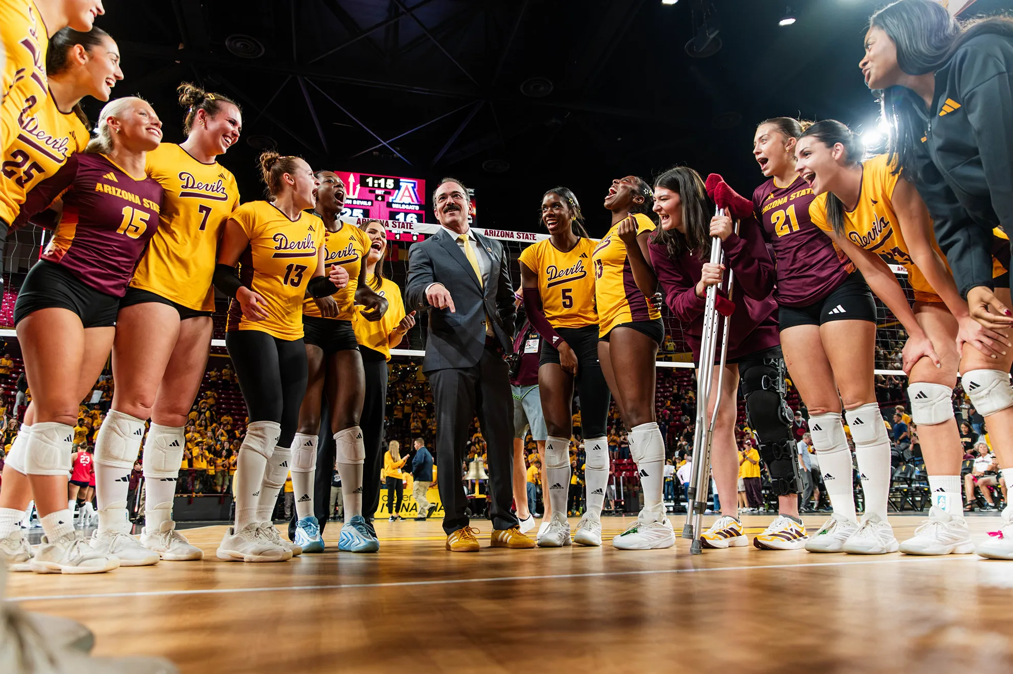 JJ Van Niel and the team cheering in a huddle.