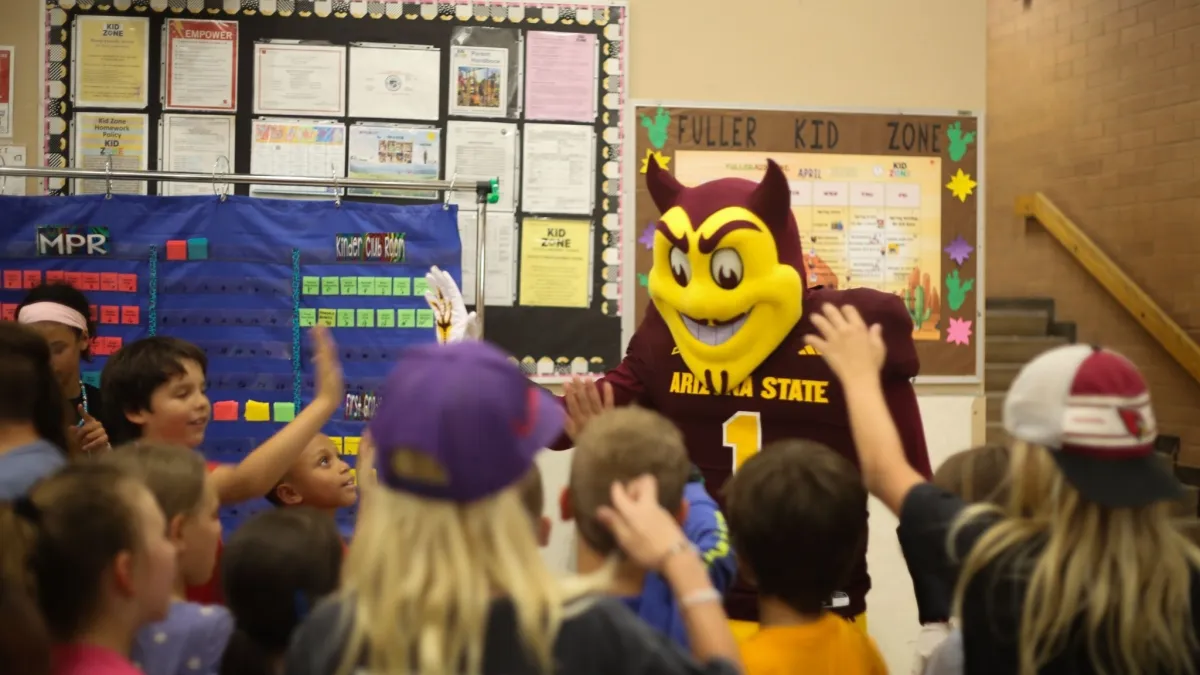 Sparky the Sun Devil interacts with elementary school children.