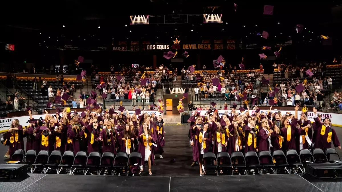 Image from ASU News class of 2024 throwing their hats up