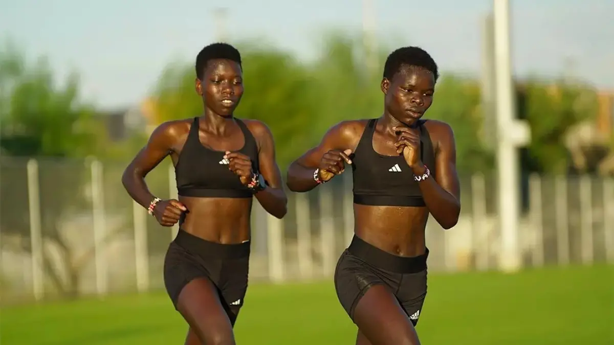 two cross country athletes running together