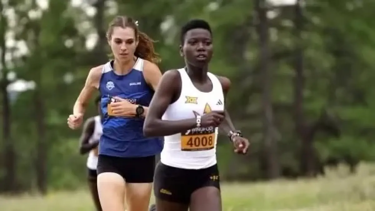 two cross country athletes running together