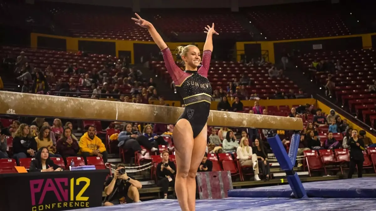 Photo by: Thomas Fernandez gymnast smiling with hands up