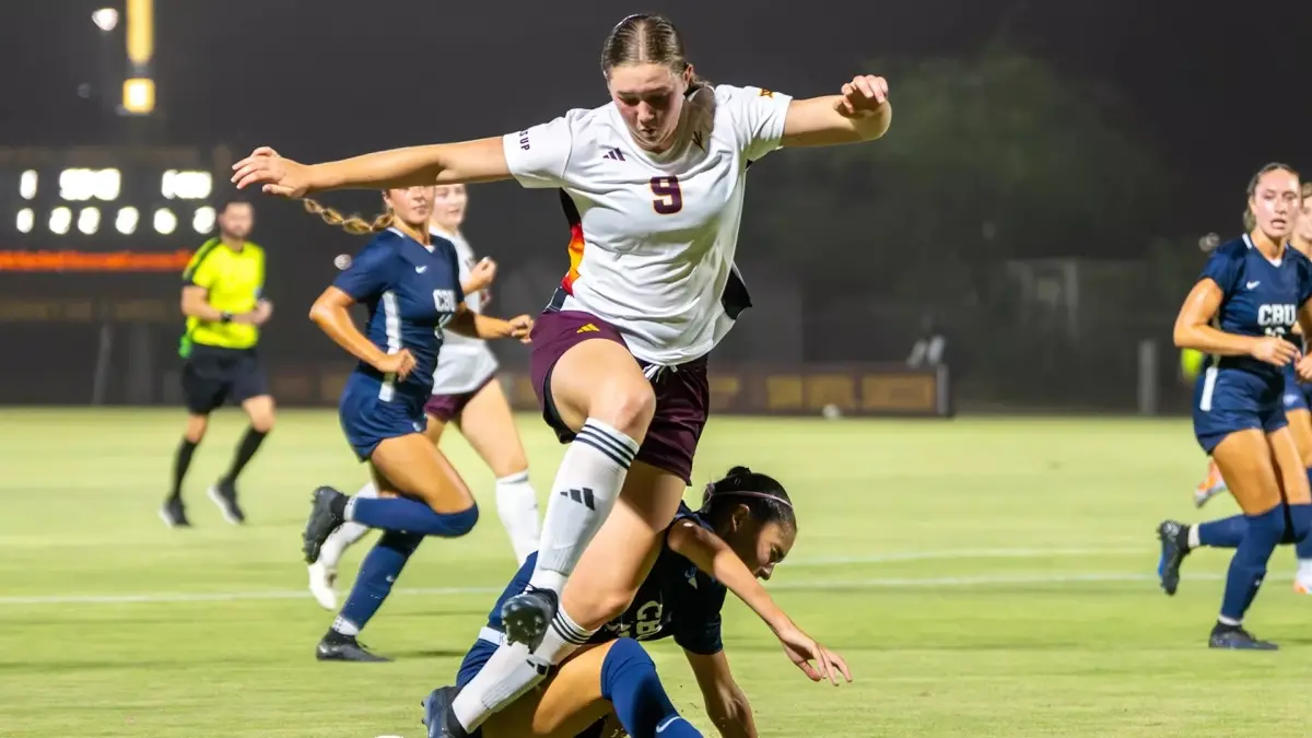 soccer player jumping over opponent soccer player jumping over opponent