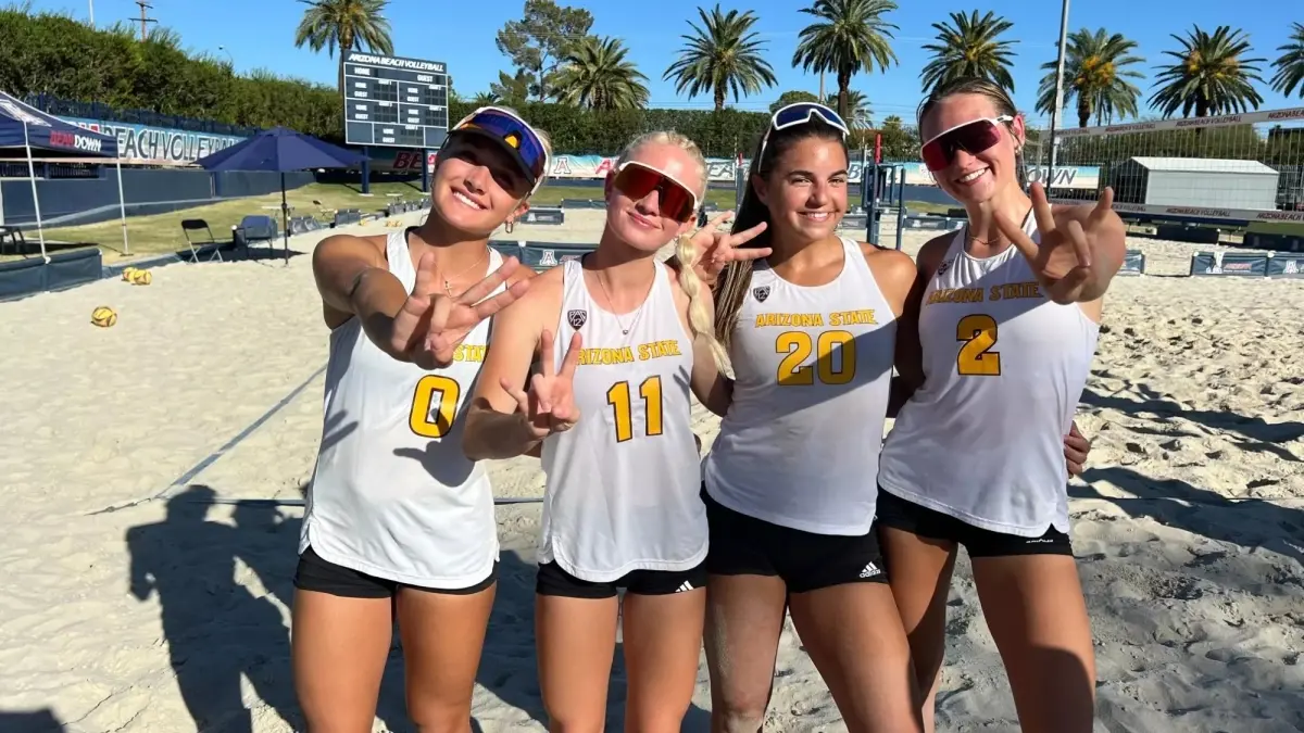 four beach volleyball players posing with jerseys four beach volleyball players posing with jerseys
