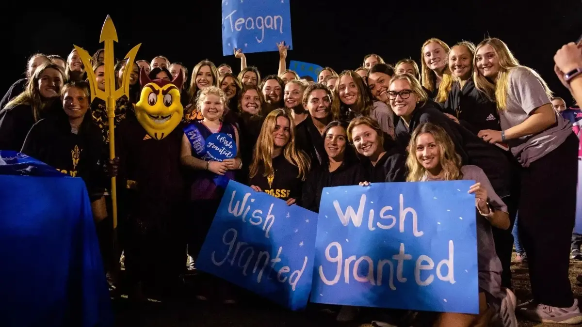 group of kids and adults holding up wish granted signs group of kids and adults holding up wish granted signs