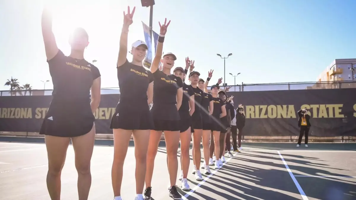 womens tennis team holding forks up in a line womens tennis team holding forks up in a line