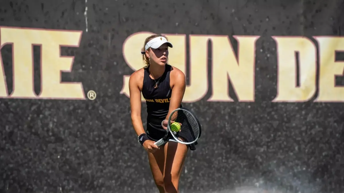 woman tennis player holding ball on racket woman tennis player holding ball on racket