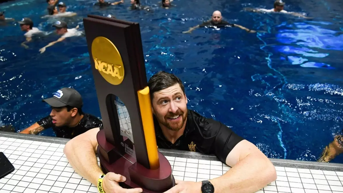 coach holding trophy while in pool coach holding trophy while in pool