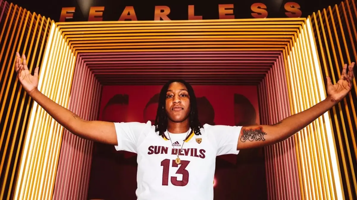 Image from ASU News woman basketball player holding arms out