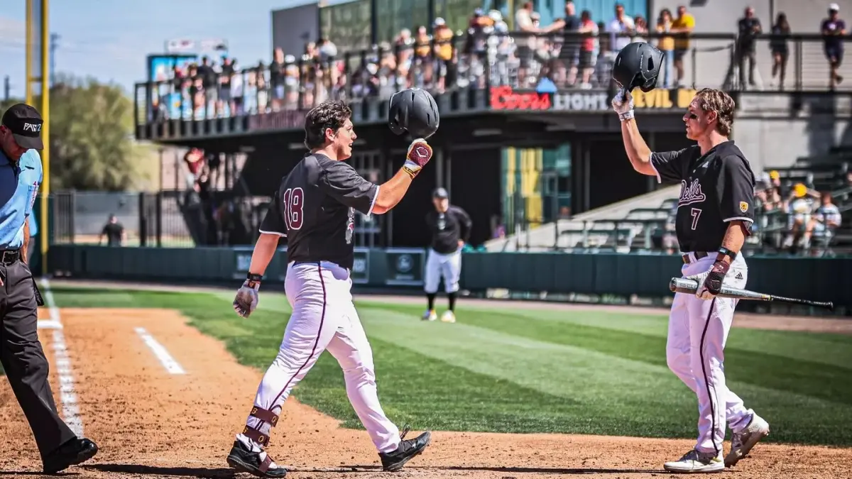 Image from ASU News two baseball players holding helmets