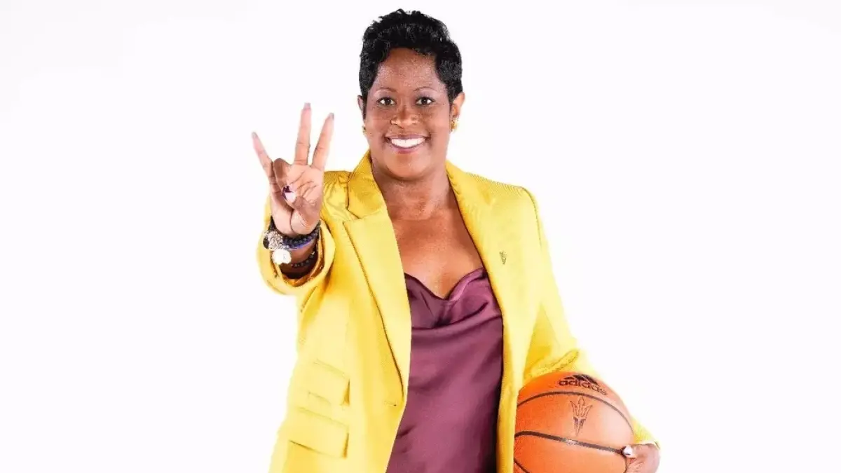 Image from ASU News basketball coach holding forks up