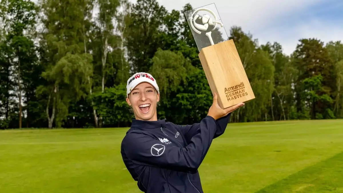 Image from ASU News woman golf player holding trophy