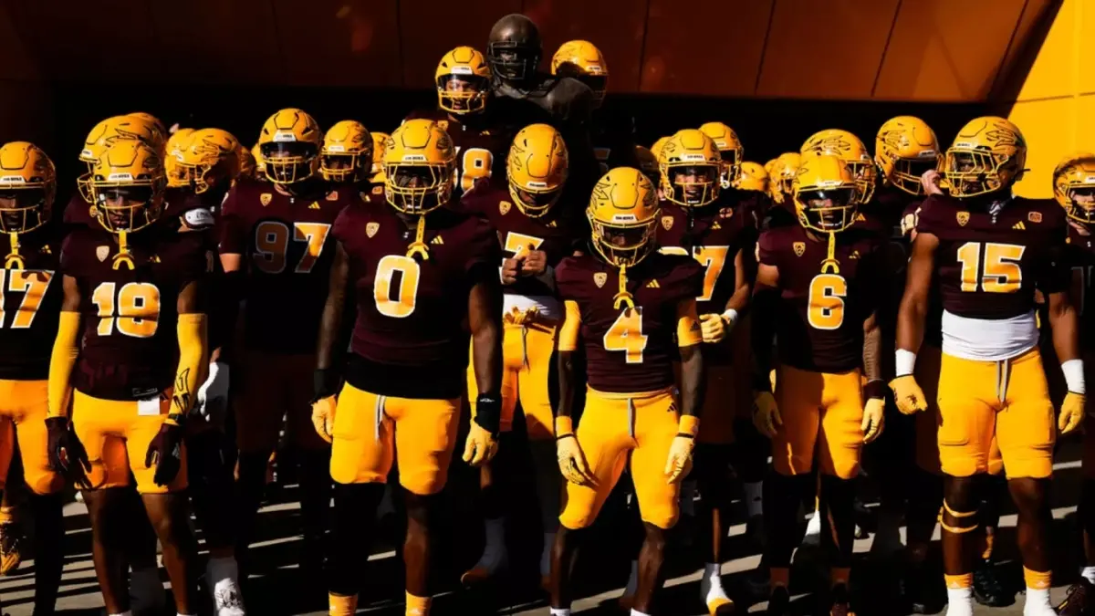 Image from ASU News football team in uniform with helmets