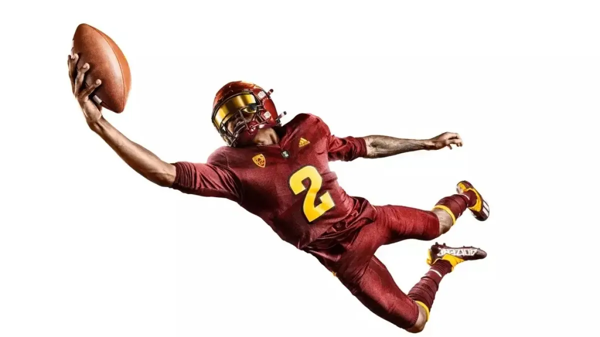 Image from ASU News football player holding ball