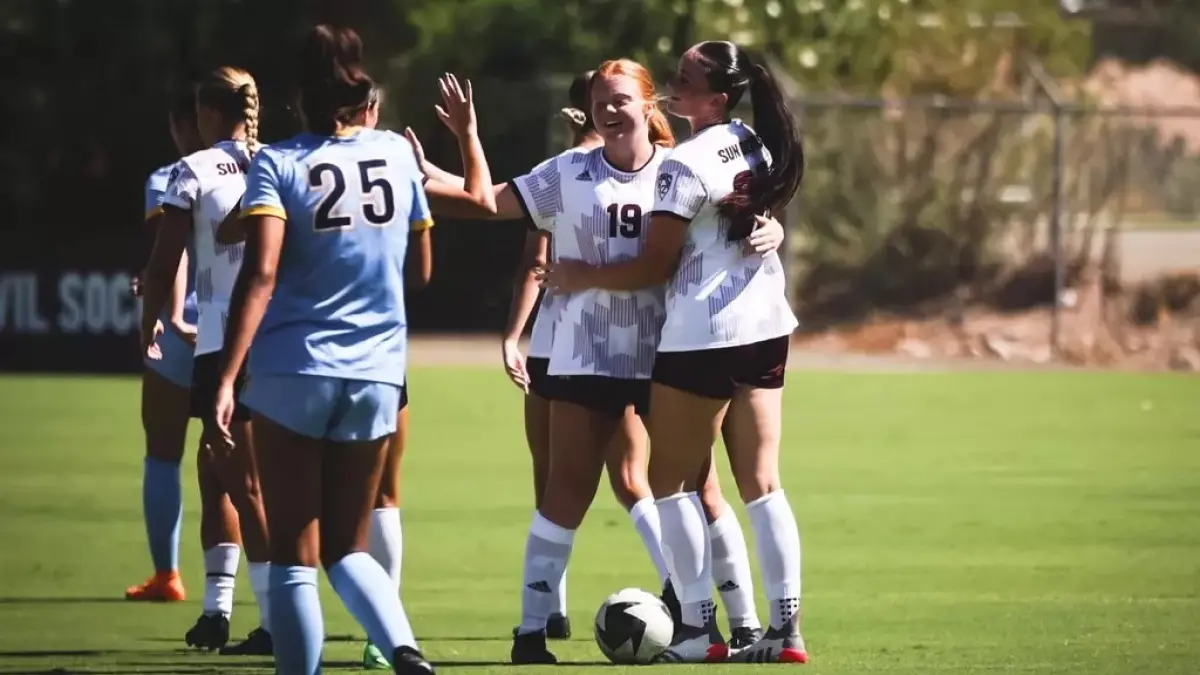 soccer team on fie3ld hugging and high fiving other team soccer team on fie3ld hugging and high fiving other team