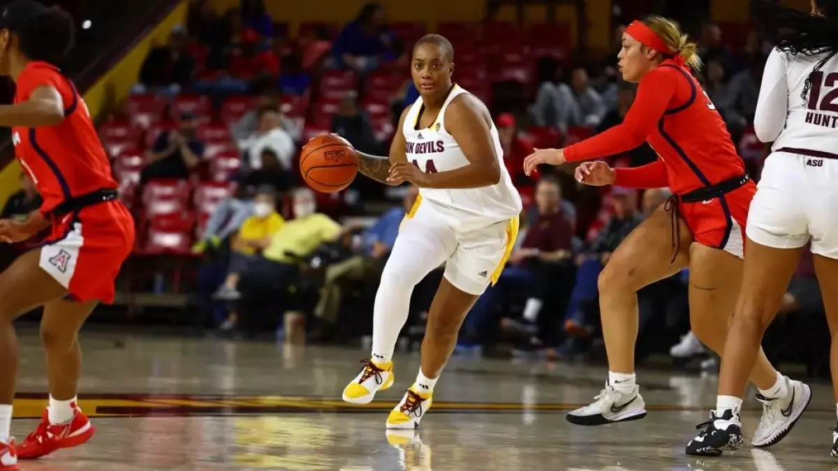 woman dribbling ball with other woman playing defense woman dribbling ball with other woman playing defense