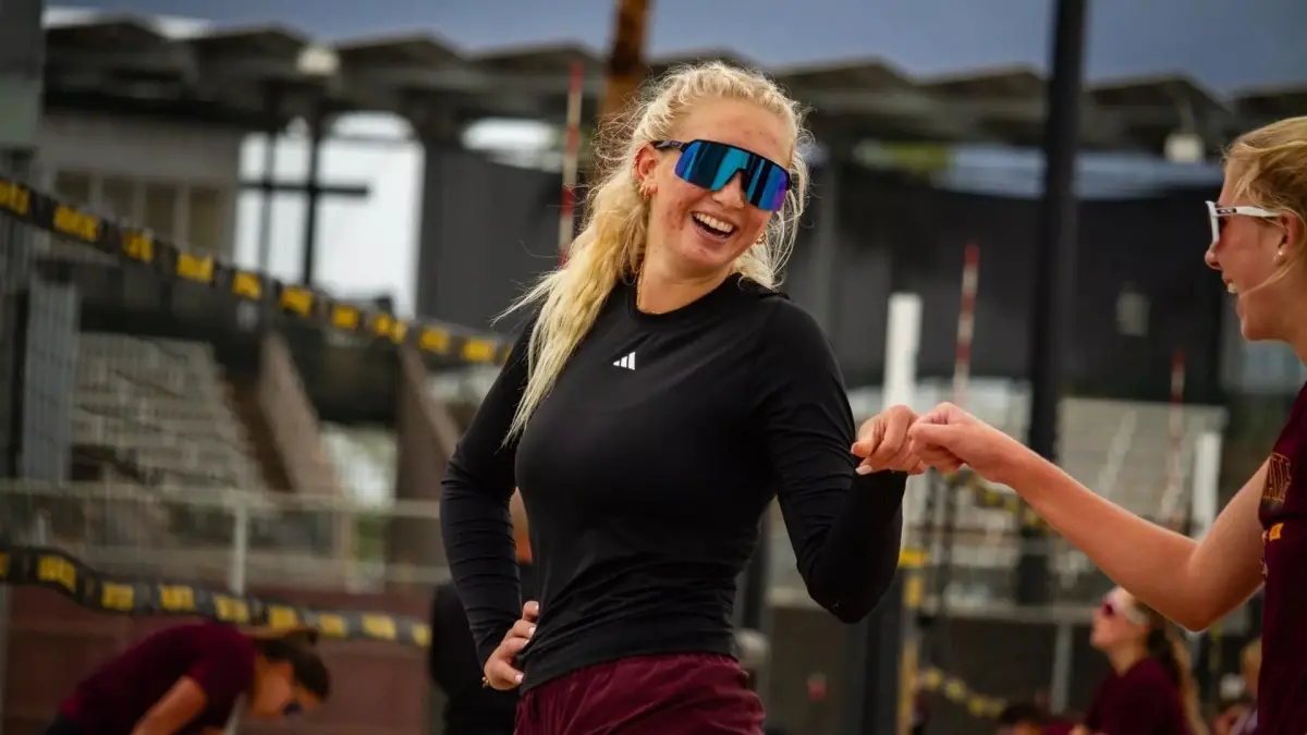 two beach volleyball players dabbing each other up two beach volleyball players dabbing each other up