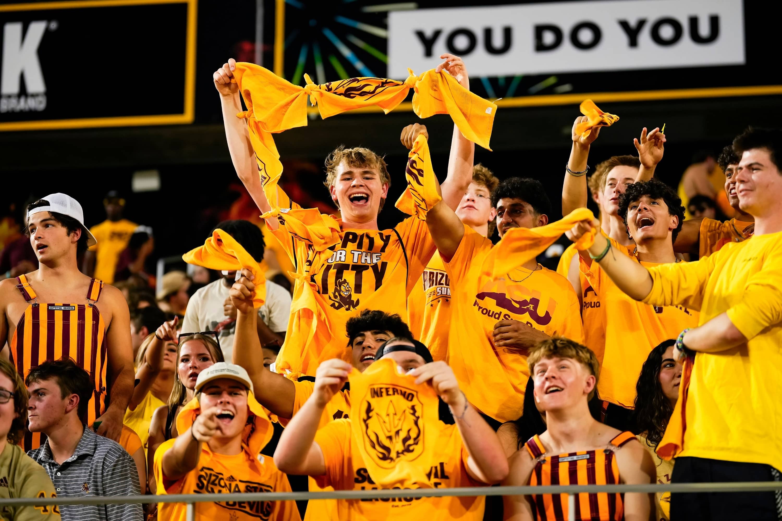 Fans with rally towels at Sun Devil sporting event