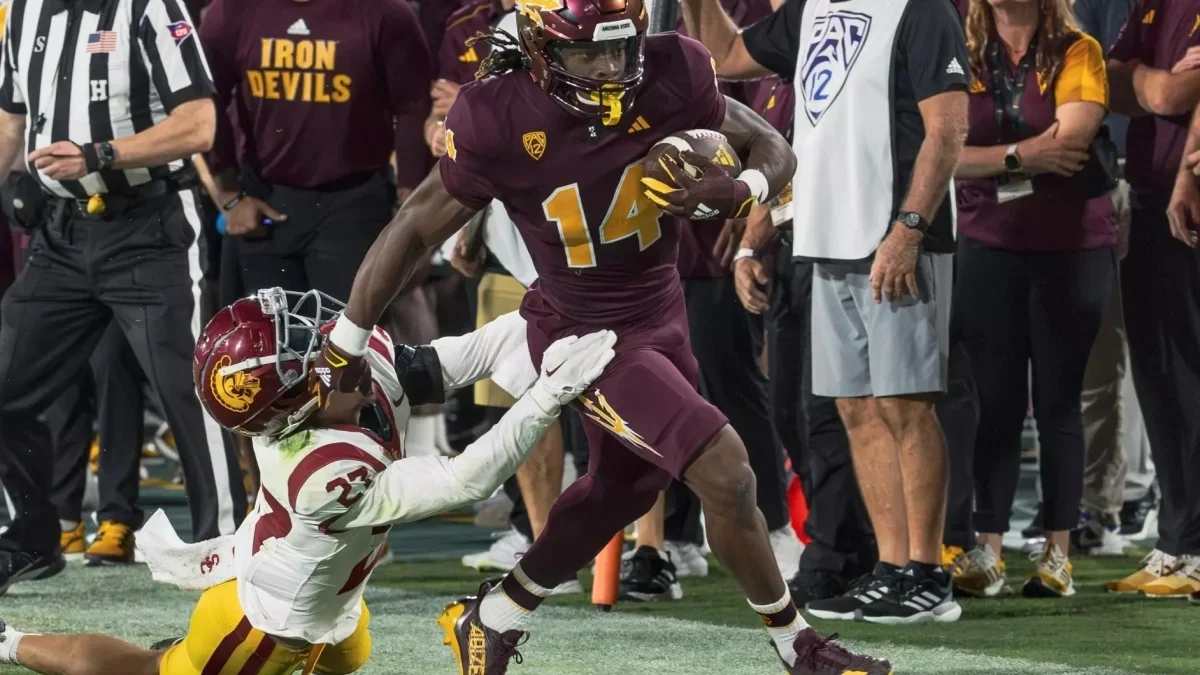 Image from ASU News two football players on field running with a ball