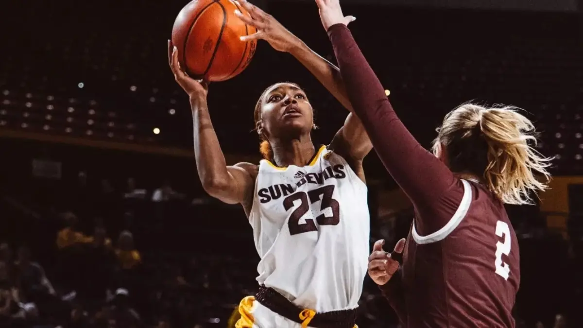woman basketball player shooting a basketball