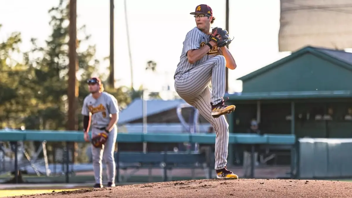 Image from ASU News one baseball player standing, another about to throw ball