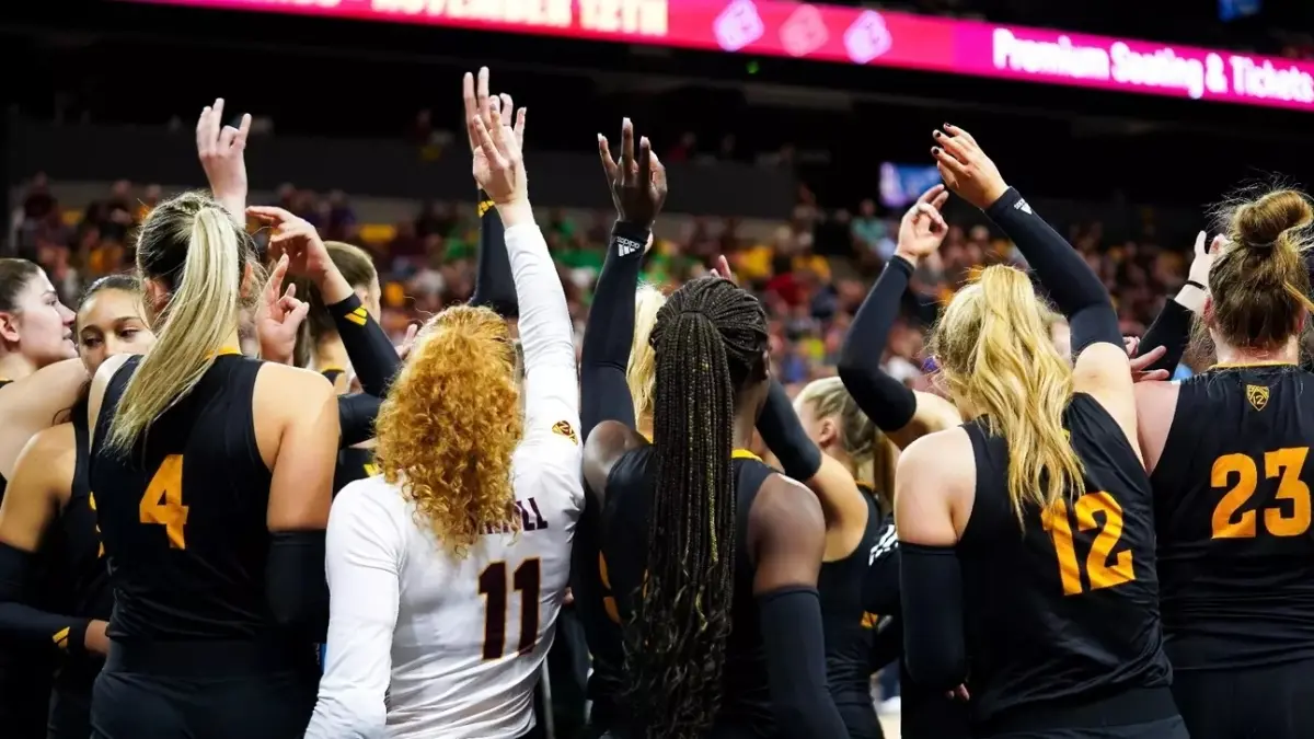 Image from ASU News Volleyball team holding up forks up in a huddle