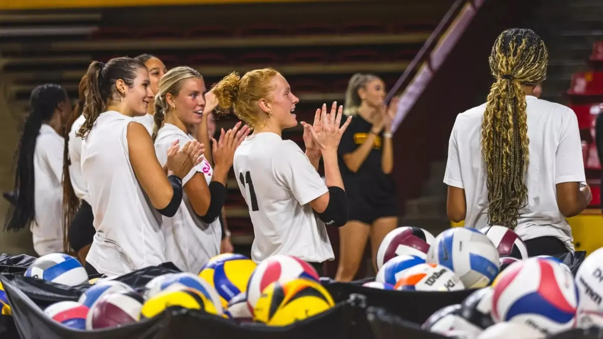 Image from ASU News volleyball team clapping on court