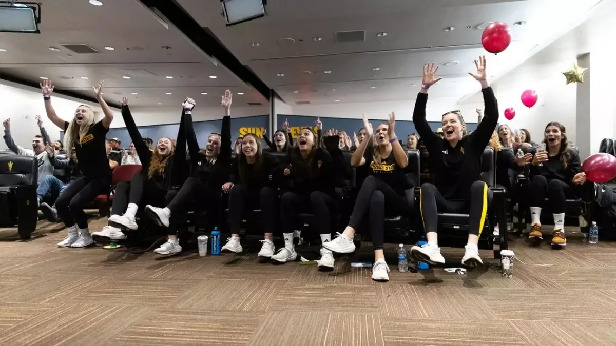 Image from ASU News Volleyball team photo sitting down with hands up