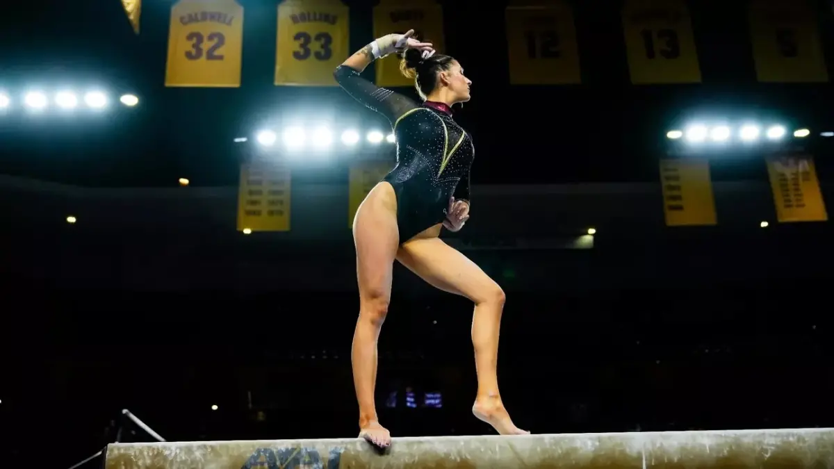 Photo by: Peter Vander Stoep
gymnast standing on beam